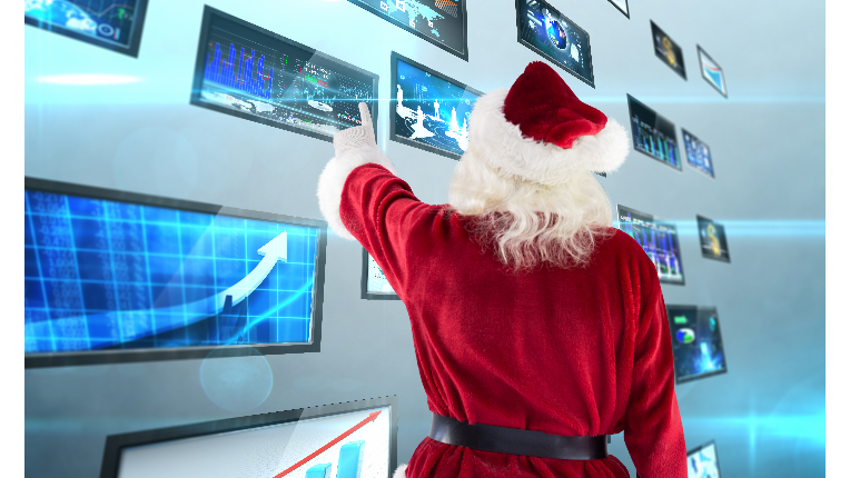 A picture of Santa Claus looking at market charts