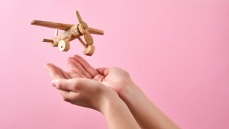 Picture of a wooden plane landing in a hand