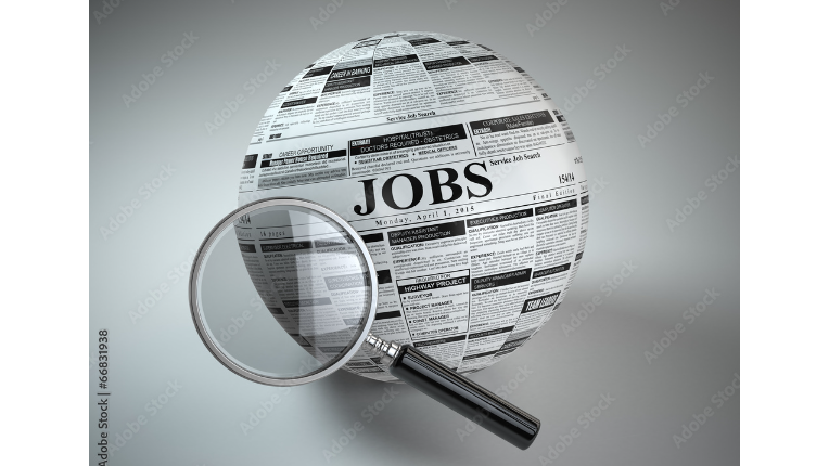 Magnifying glass hovering over the globe wrapped in job want ads