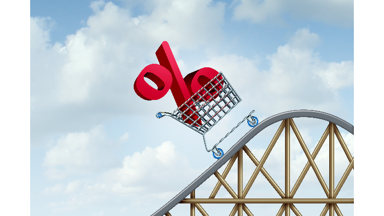 A percent symbol in a shopping cart on a roller coaster