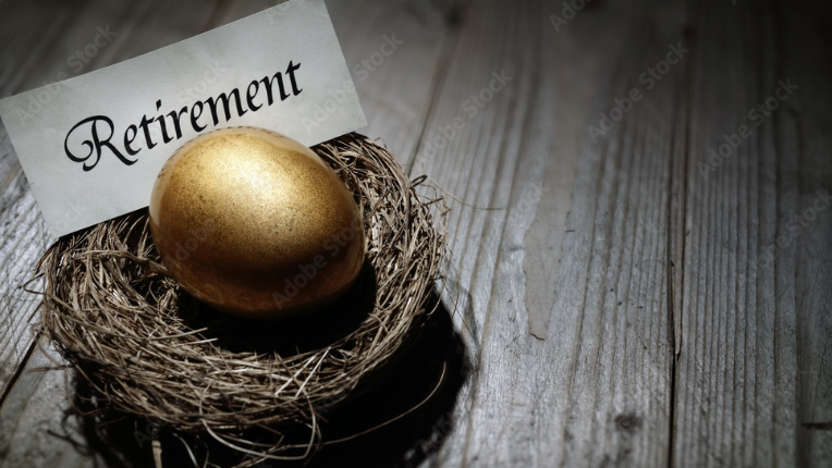 Nest with golden egg and parchment with the word Retirement.