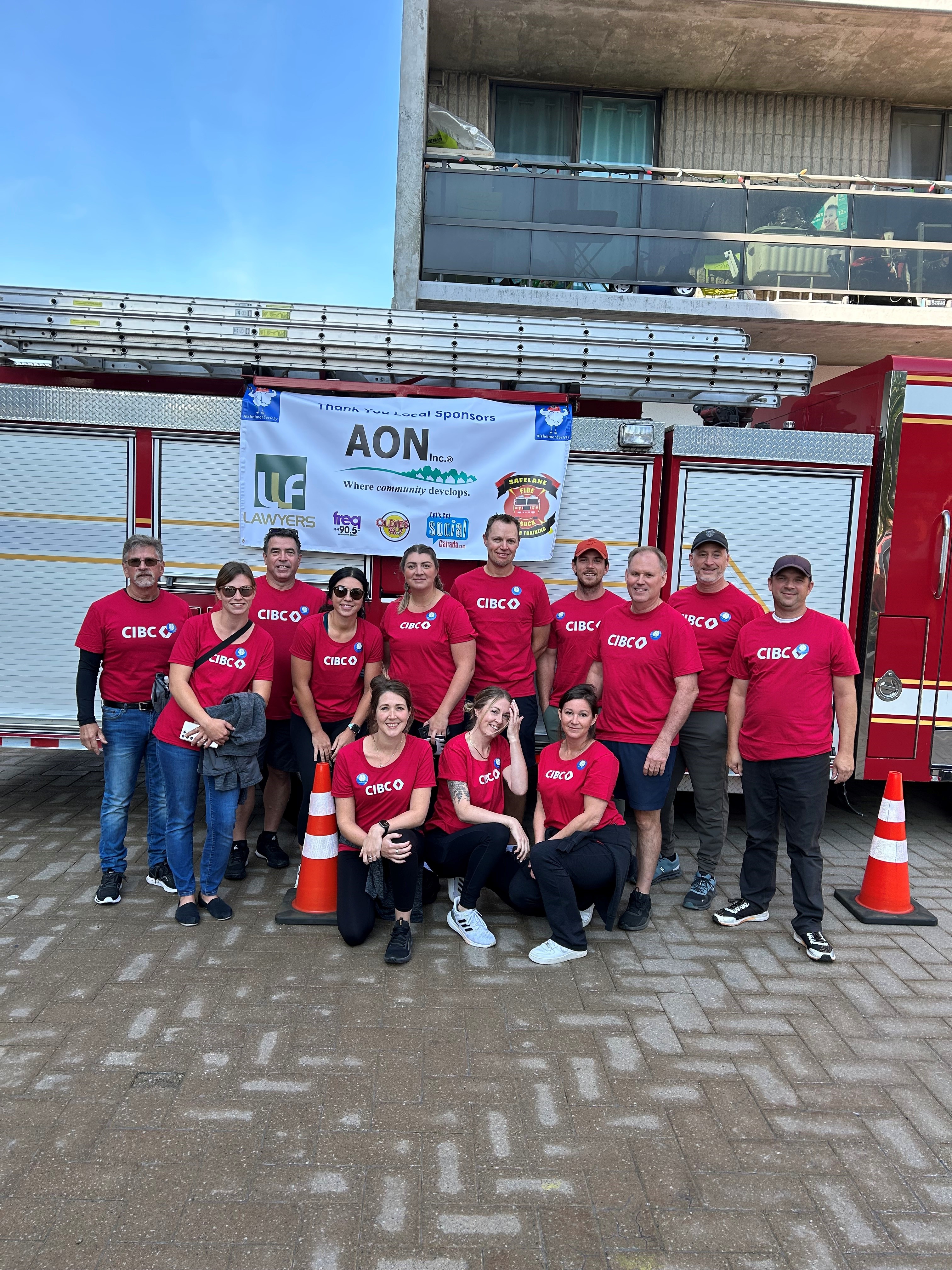 CIBC Wood Gundy Team in front of firetruck. 
